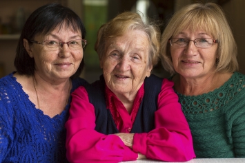 Elderly mother with daughters.